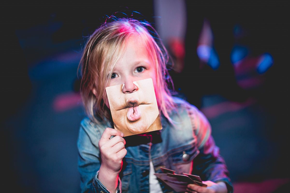 child holding photo of lips