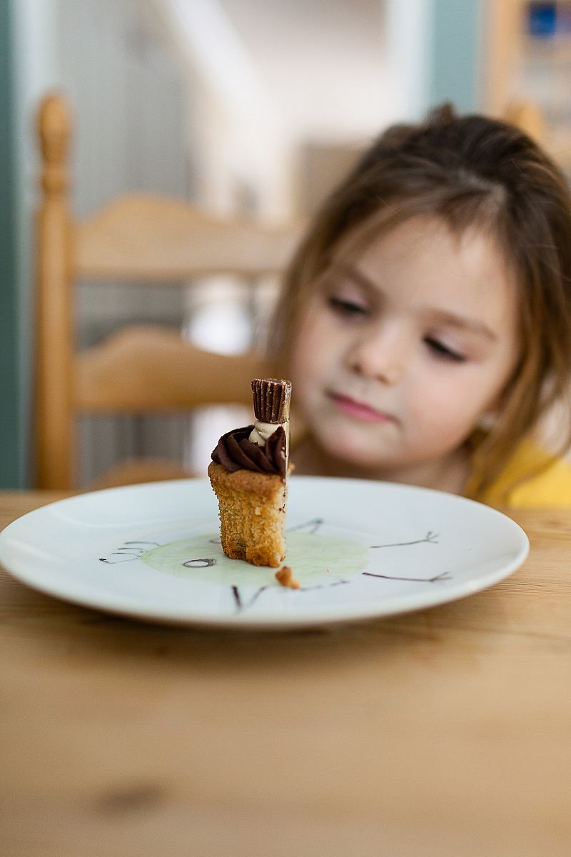 girl staring at the cake on plate