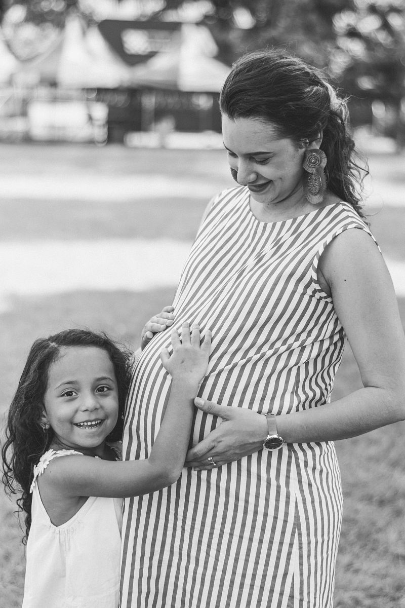 grayscale photography of pregnant woman and girl