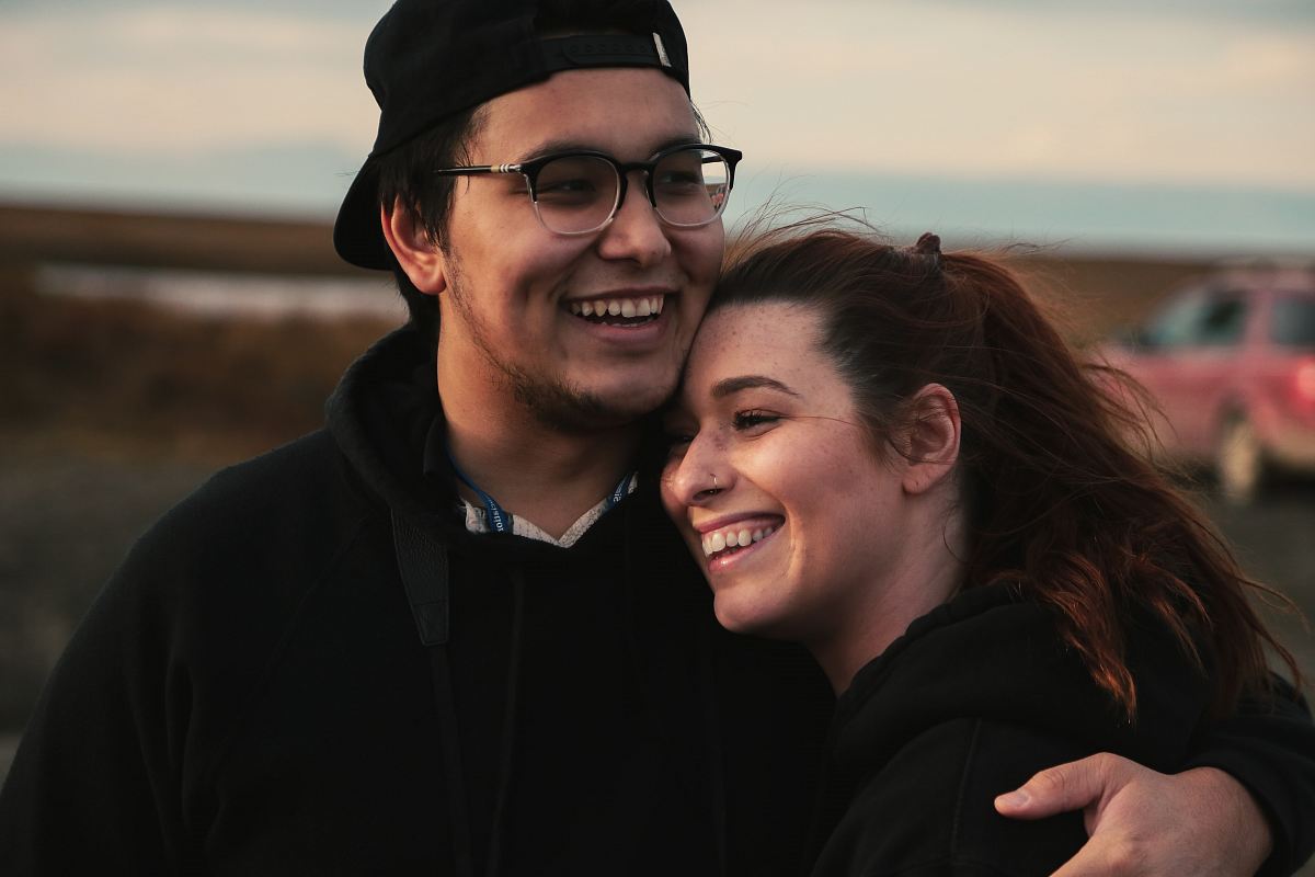 man hugging woman