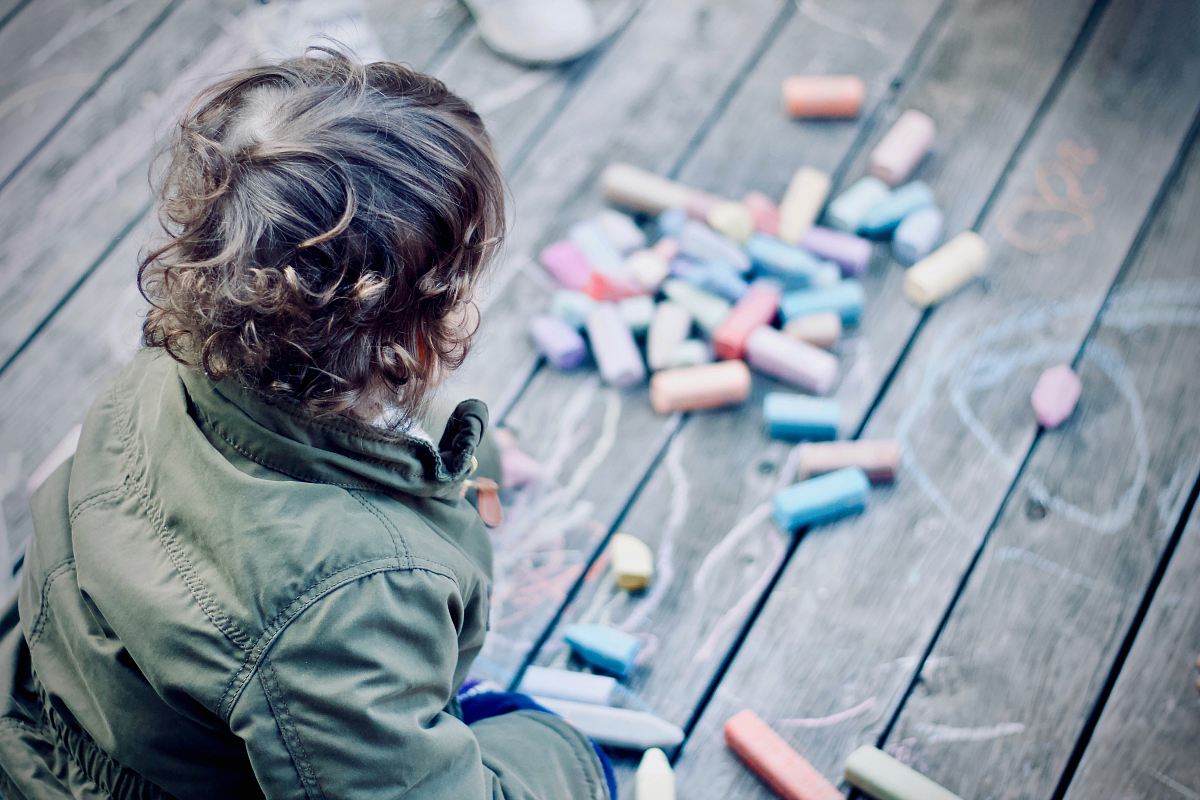 person sitting in front of assorted-color pens