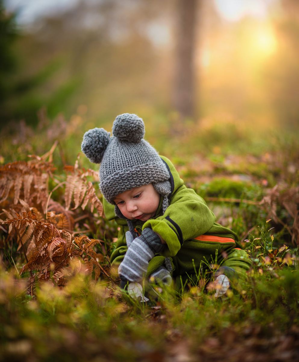 selective focus photo of baby on green grass field