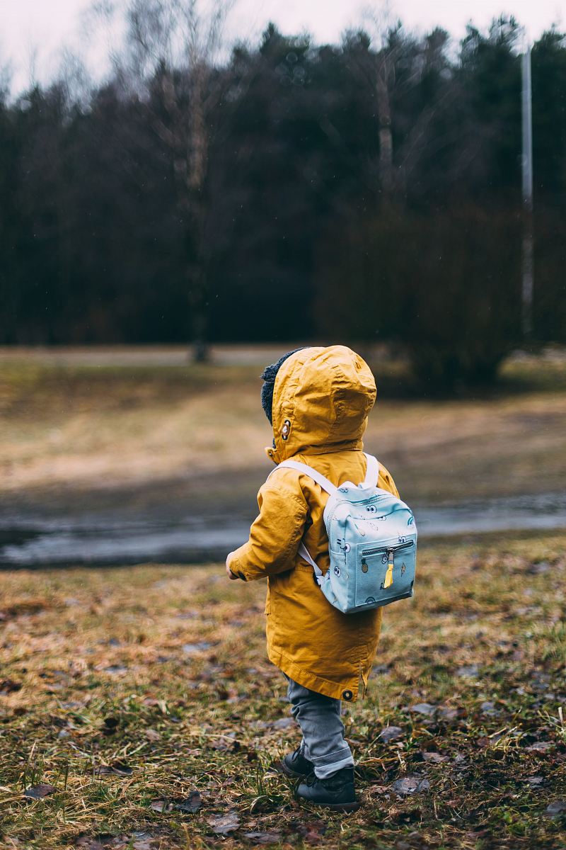 shallow focus photo of toddler walking near river