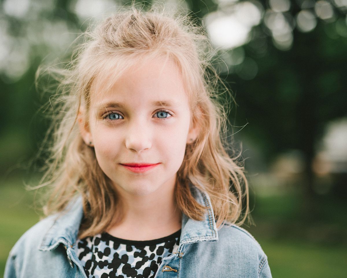 smiling girl in blue denim jacket