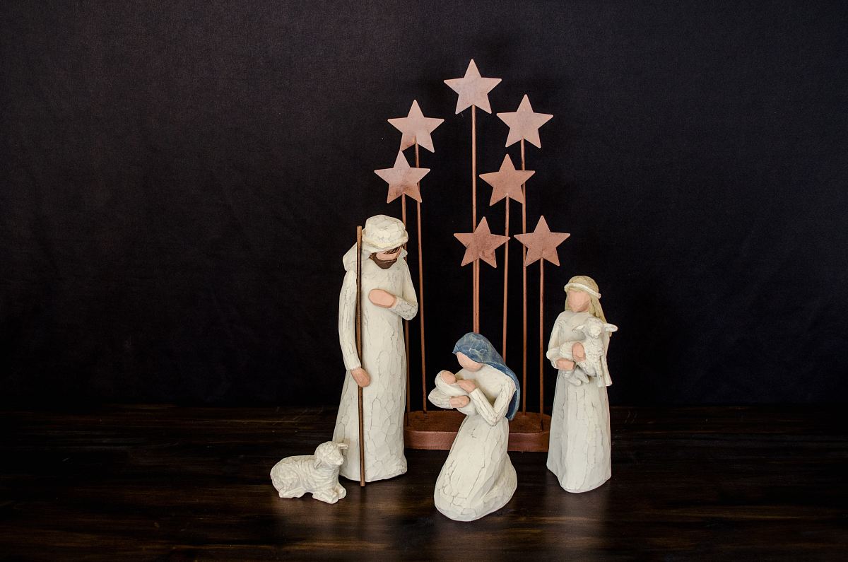three religious figurines on brown surface