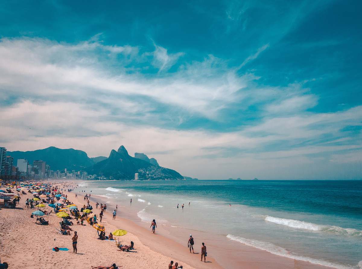 ocean group of people sunbathing on beach water