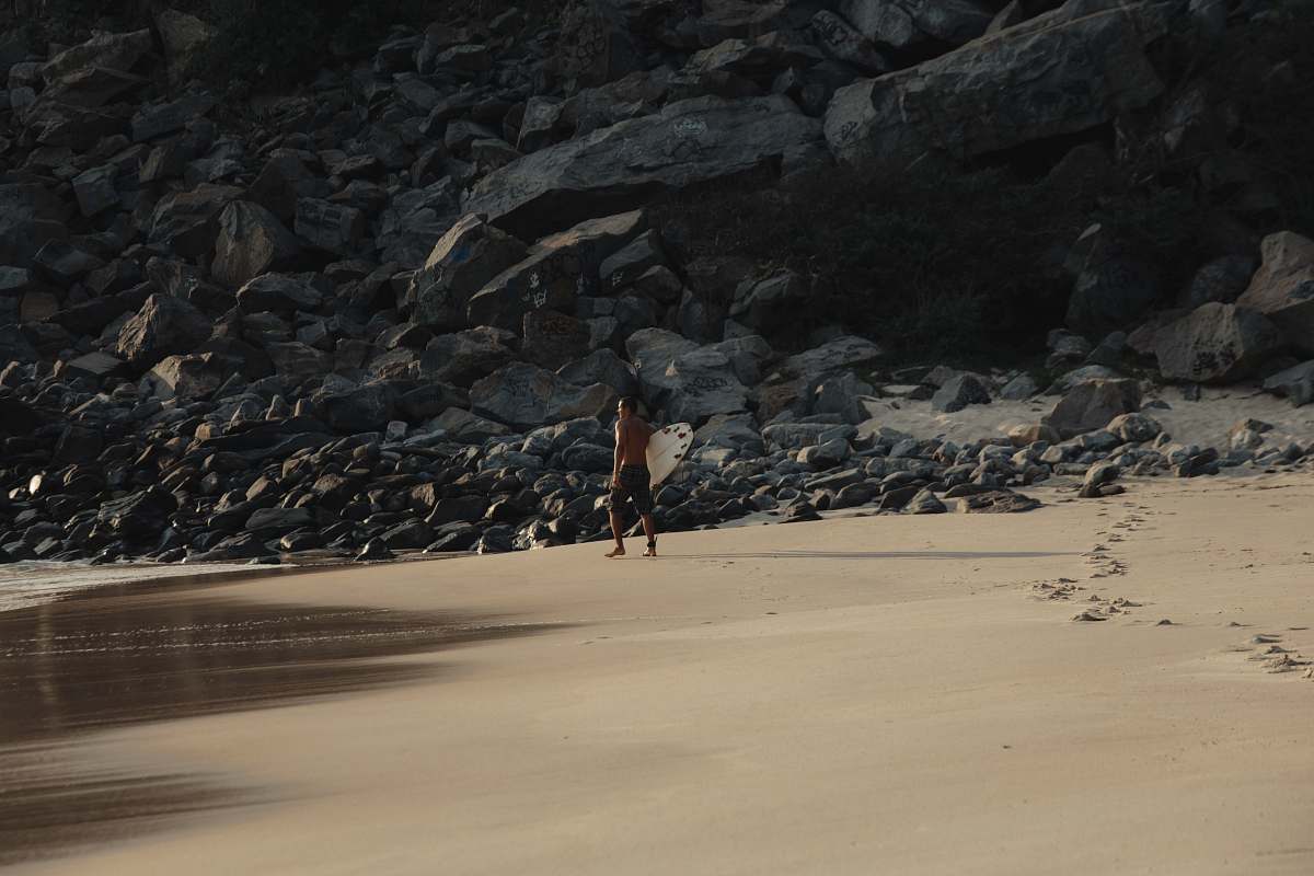 prainha person standing near rock formations rock