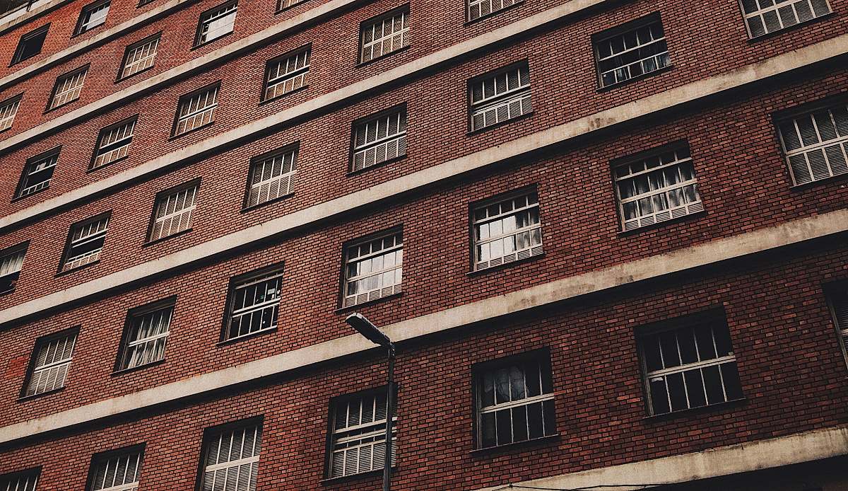brick low-angle photography of brown concrete building city