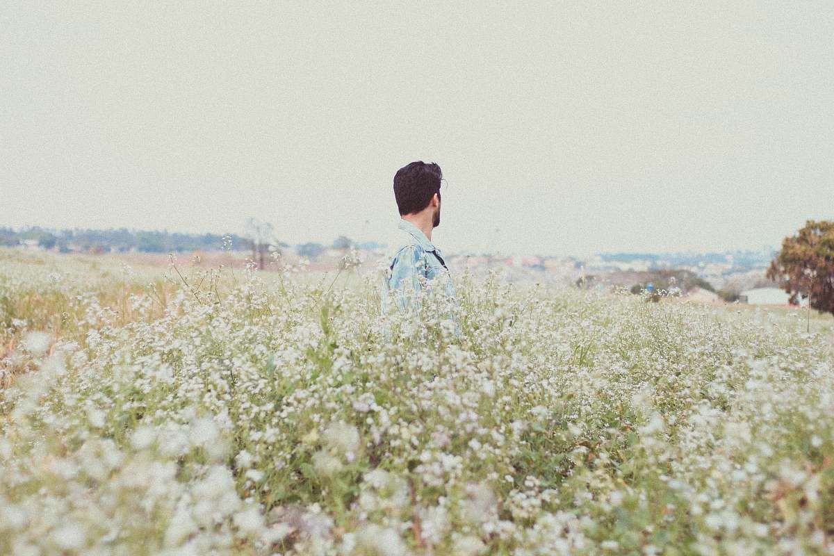 person man in garden of flowers field
