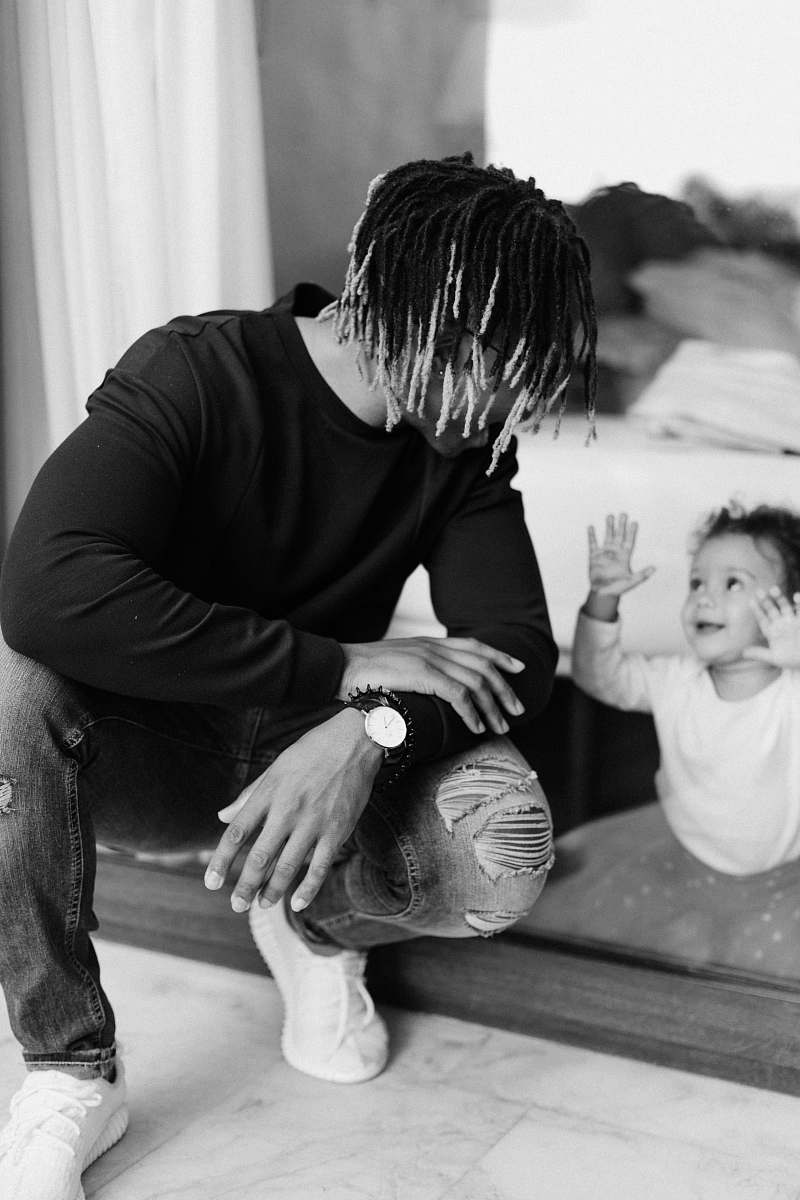 black-and-white shallow focus photo of man talking to baby person