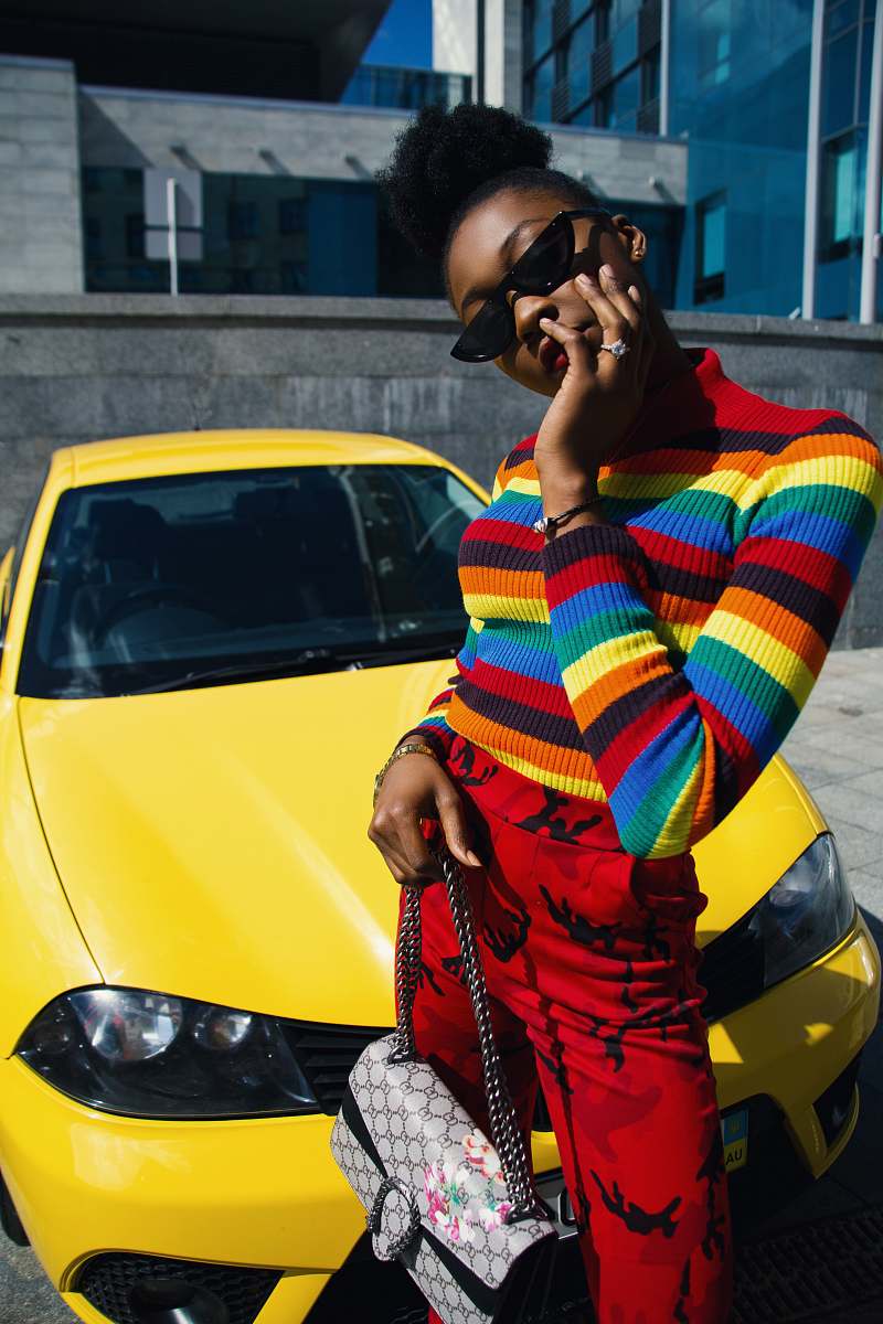 person woman standing in front of yellow car people