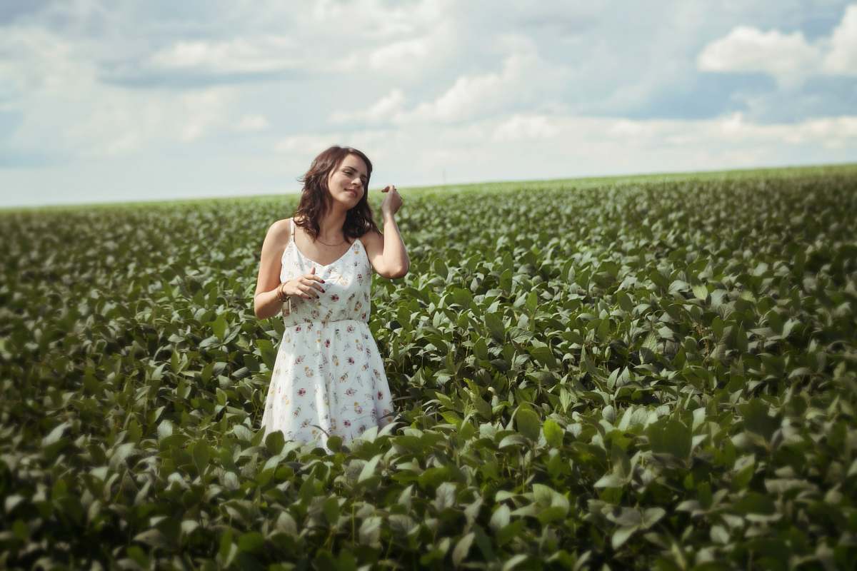 person woman standing in green leafed plant field during daytime people