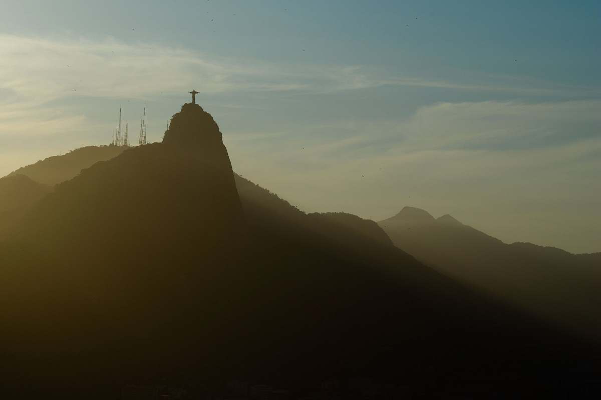 outdoors silhouette of cross on top of mountain at daytime mountain