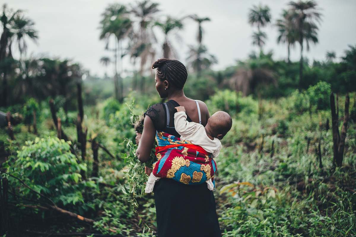 human baby clinging on back person