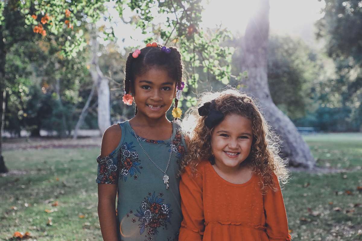 human two dressed children standing against trees people