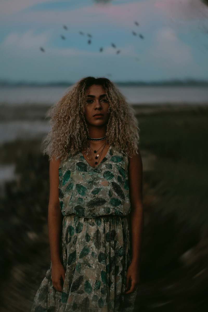 people woman posing for photo near sea during daytime human