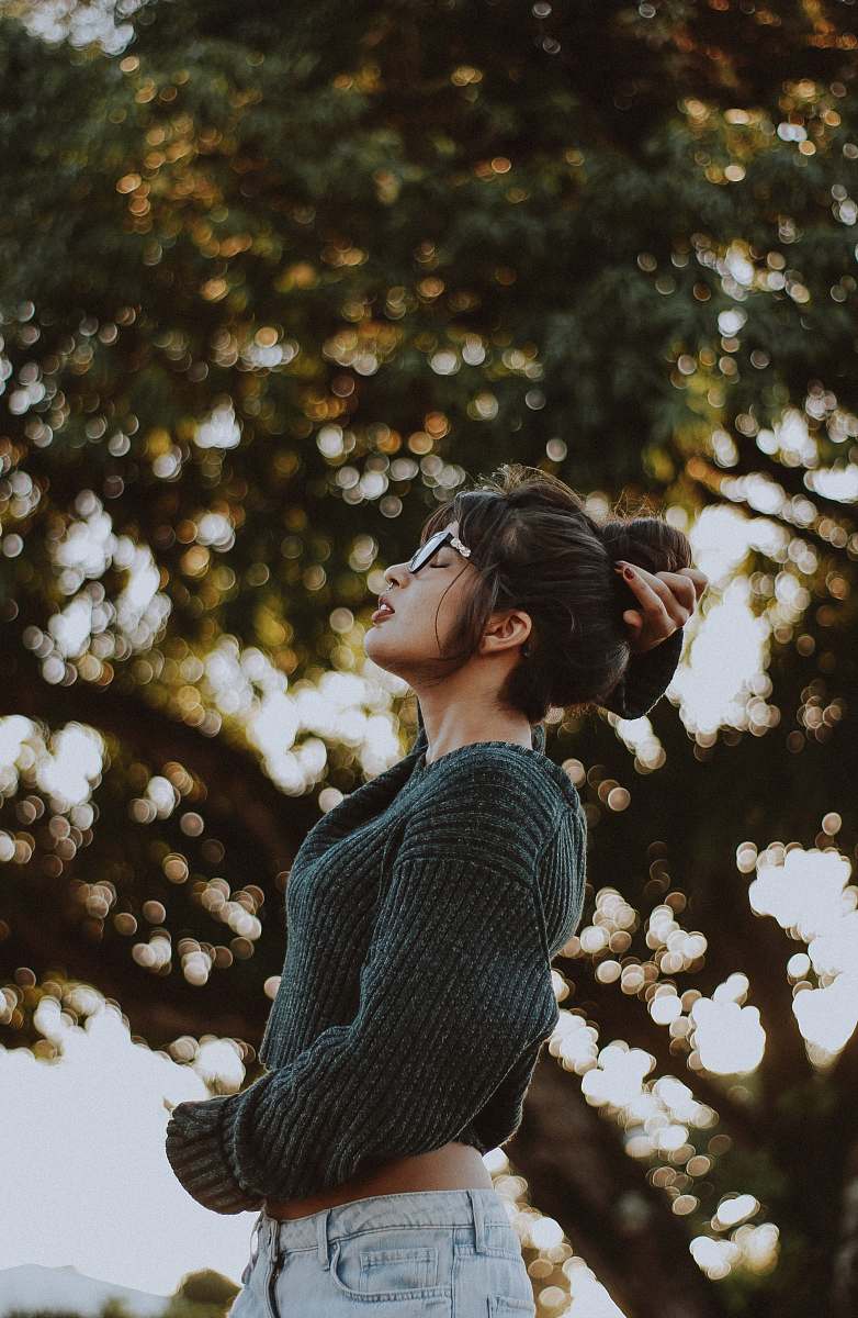 people woman wearing gray sweater near tree human
