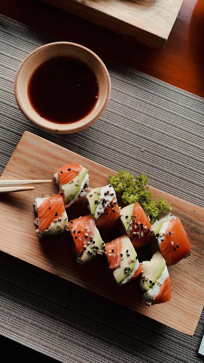 seasoning sushi on white ceramic plate sesame