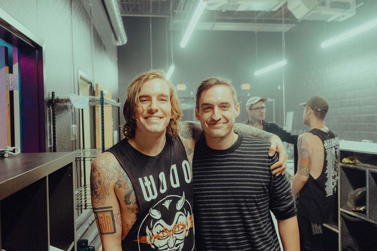 person two man standing near shelf tattoo