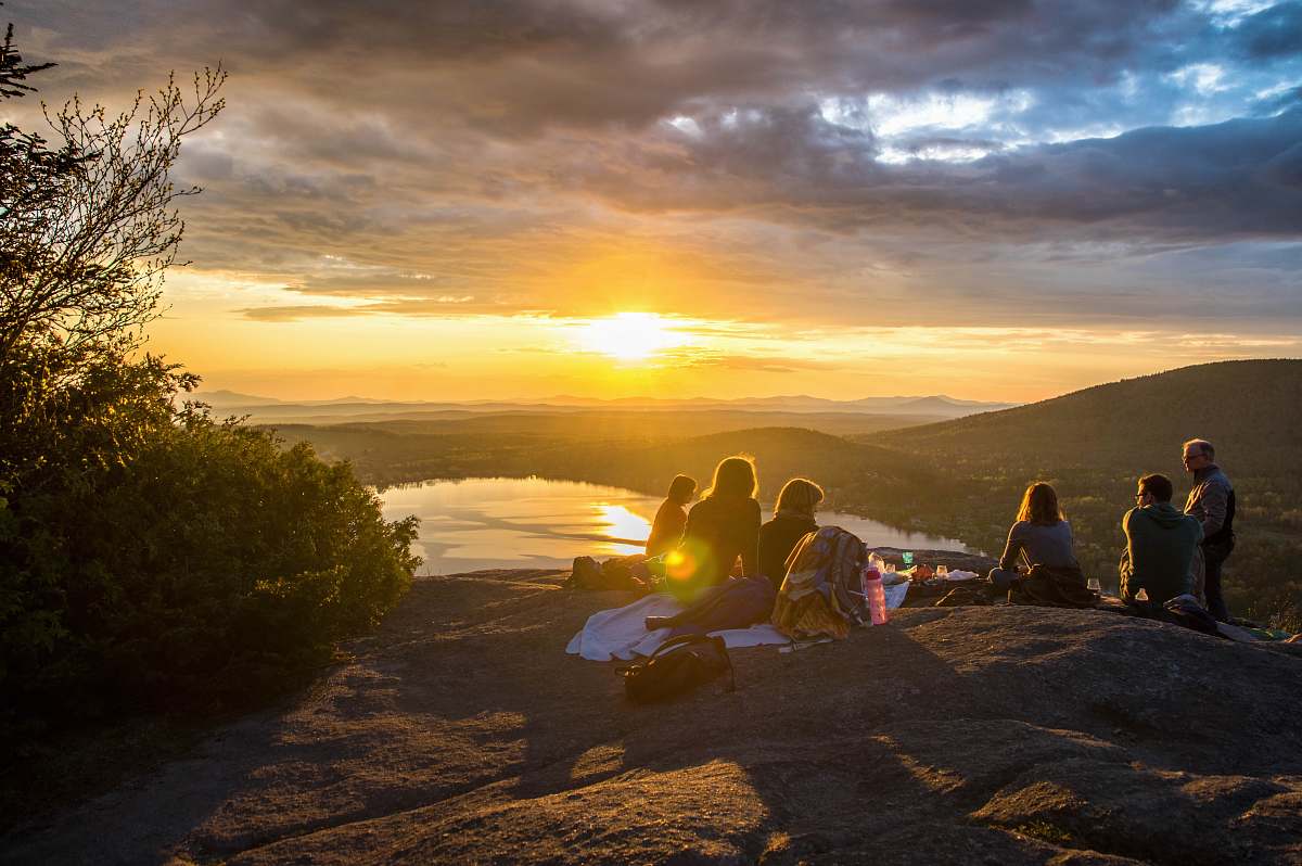 group group of people sirring under sunset friend