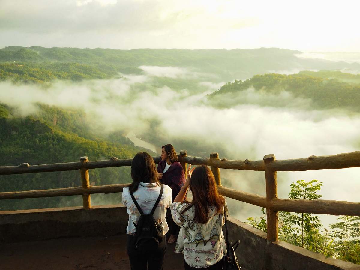 human three woman standing on mountain cliff person