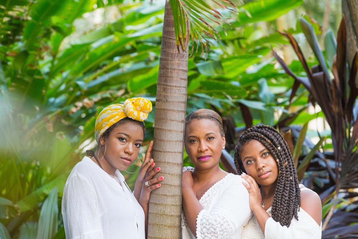 human three women standing beside tree person