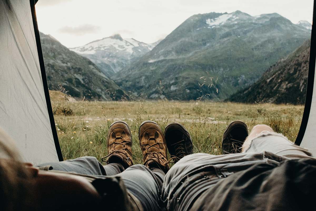 mammal two person lying on tent animal
