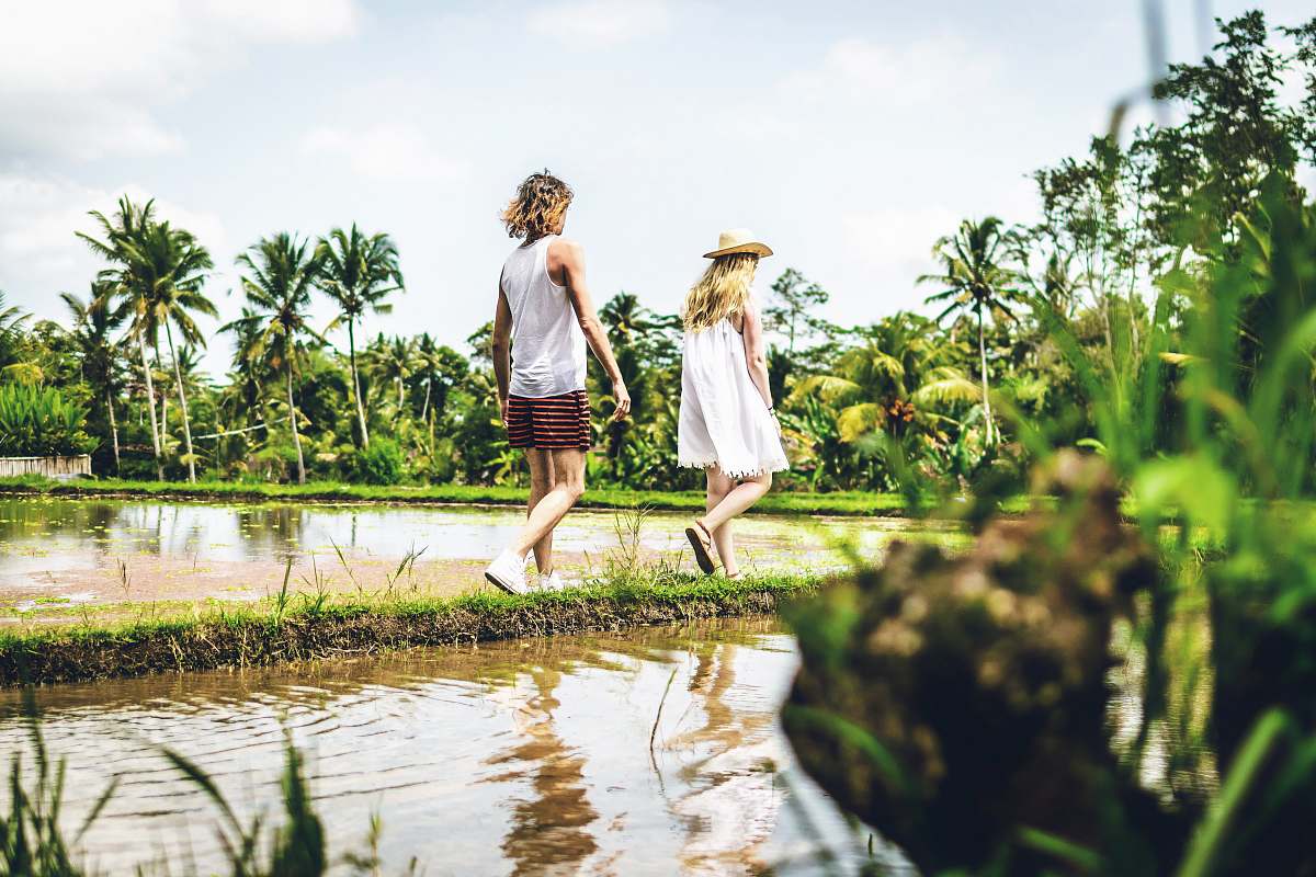 clothing man and woman walking in rice field human