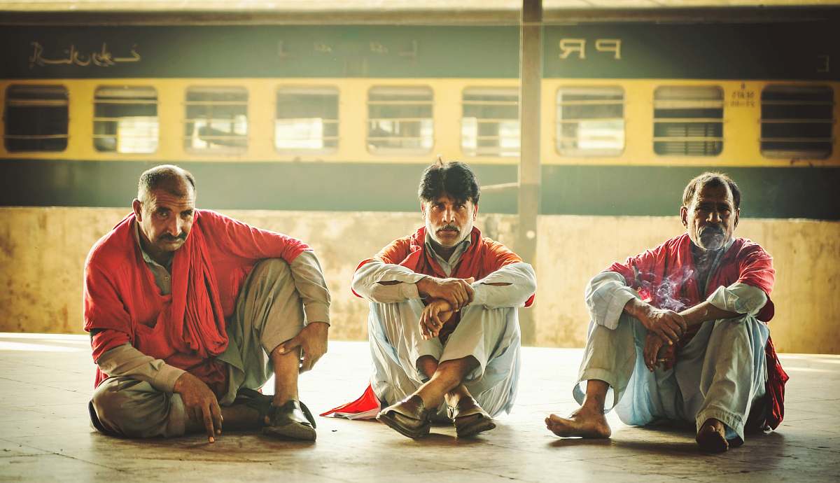 person three men sitting on floor monk