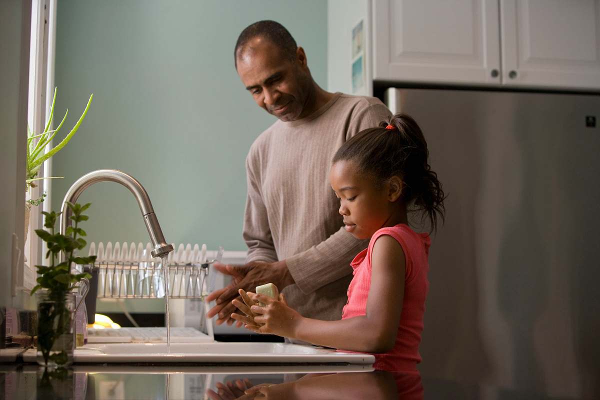 human man in white long sleeve shirt sitting beside woman in pink long sleeve shirt sink