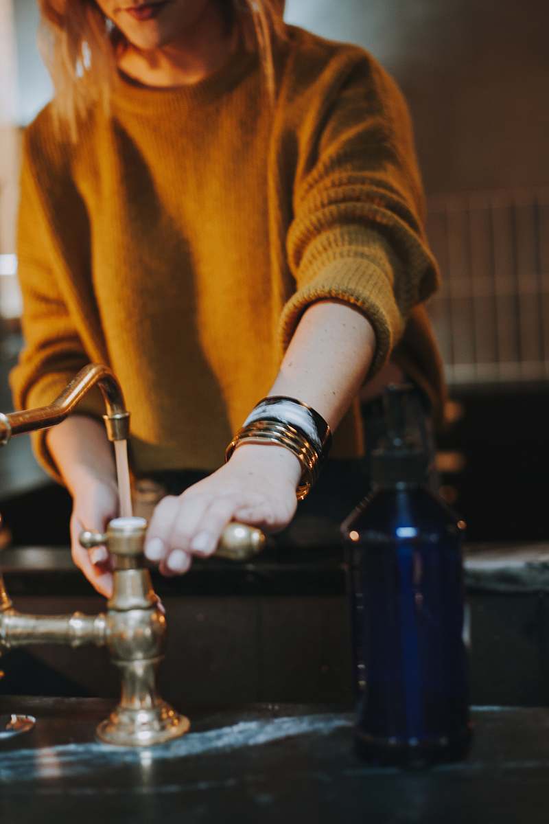 chess photo of woman holding brass-colored faucet game