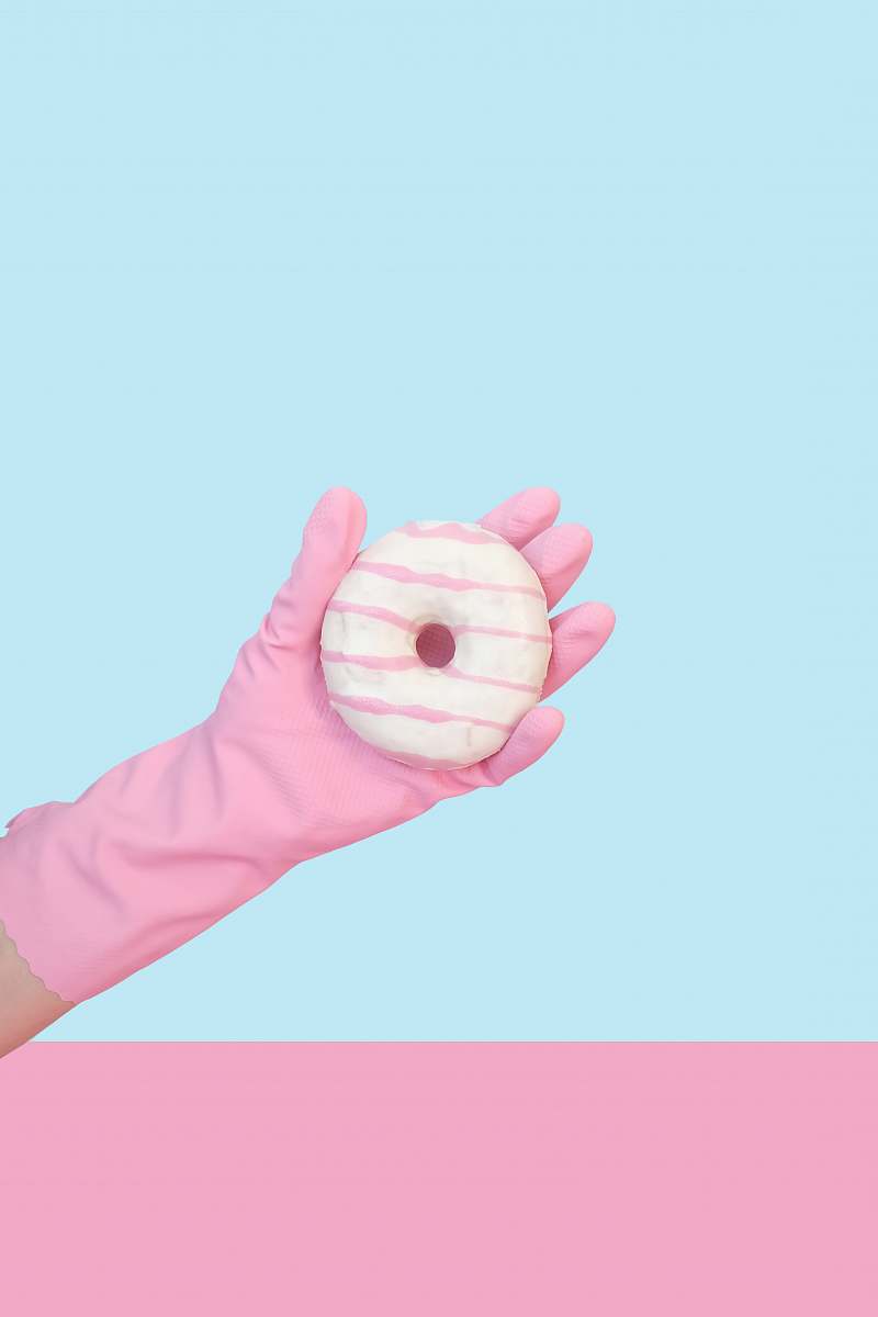 food person holding doughnut with cream donut