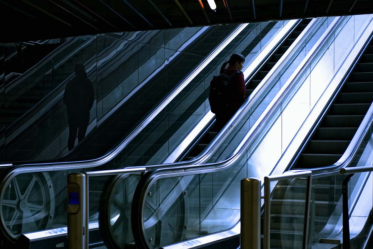rotterdam woman standing at escalator escalator