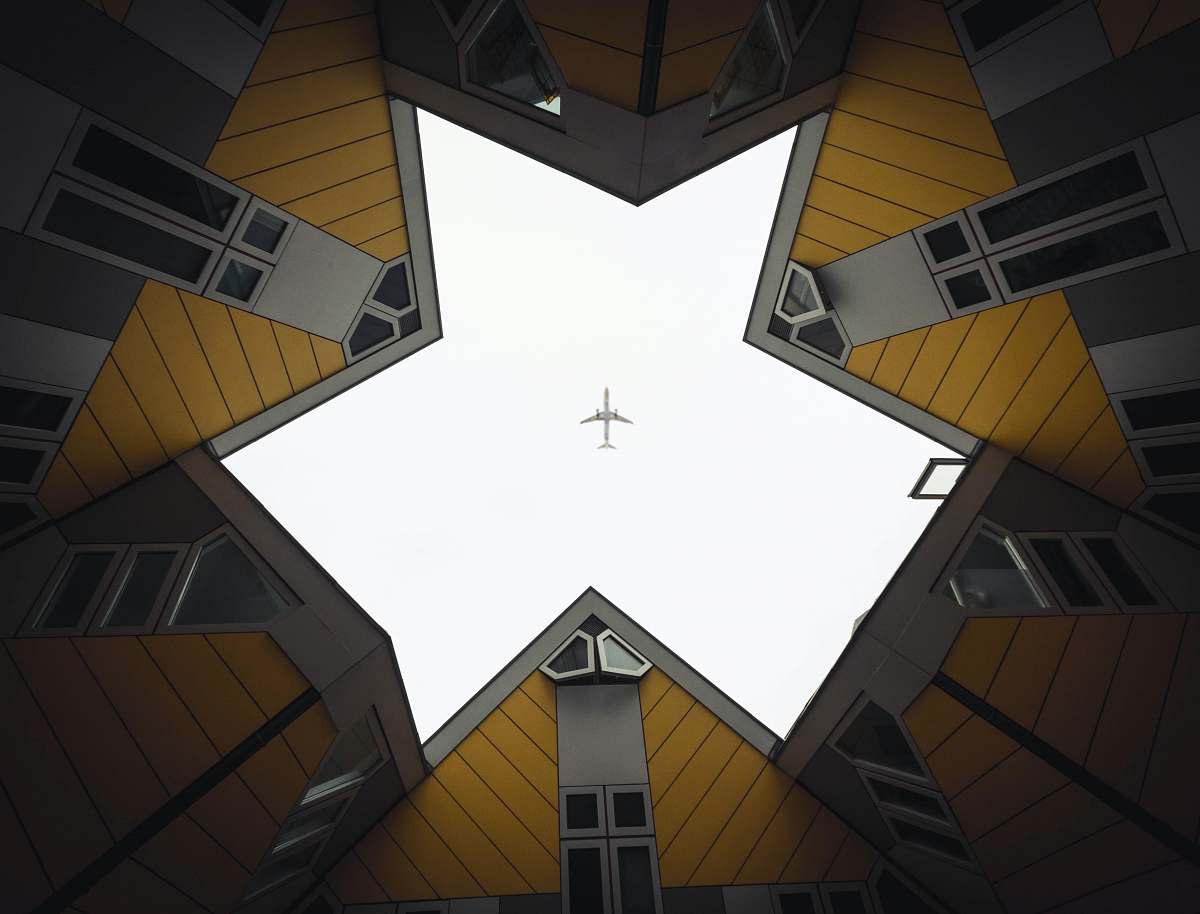 rotterdam worm's eye view of building showing airplane in the sky building