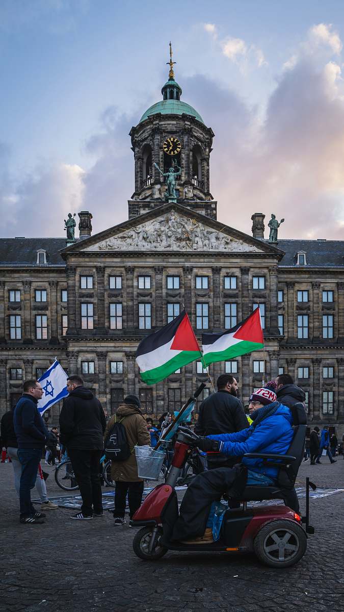 human people walking on street near building during daytime dam square