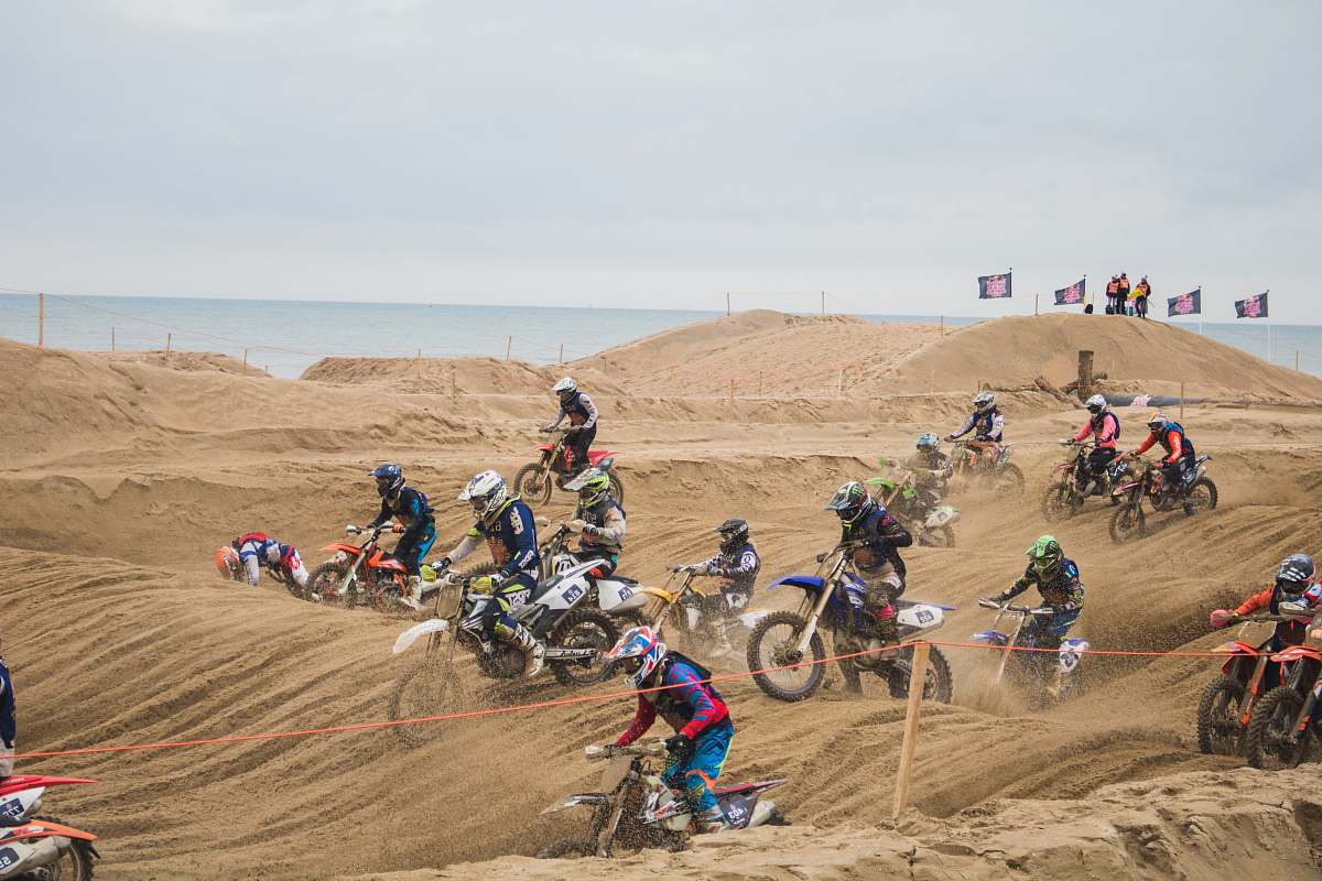 vehicle people riding dirt bike during daytime motorcycle