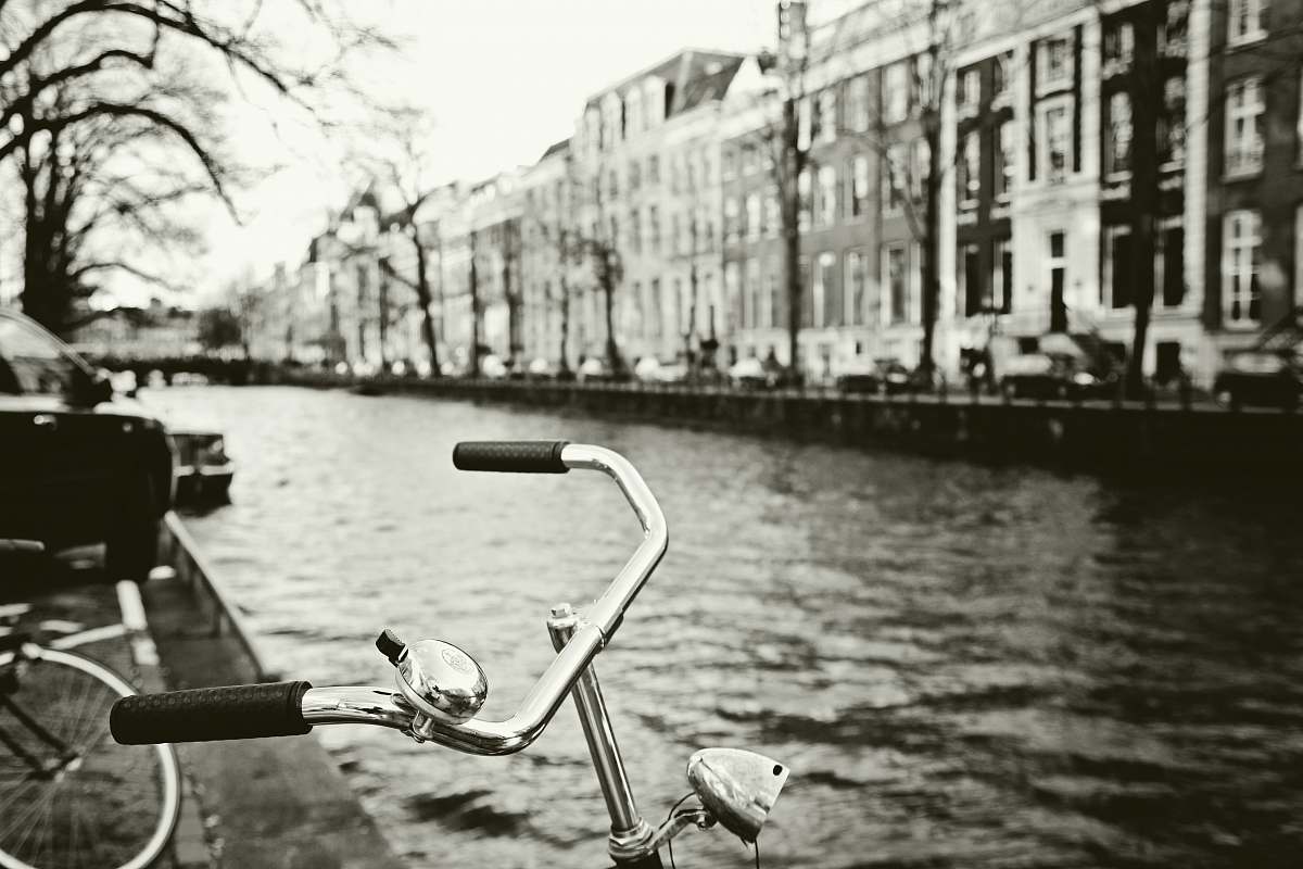outdoors grayscale photo of bicycle canal