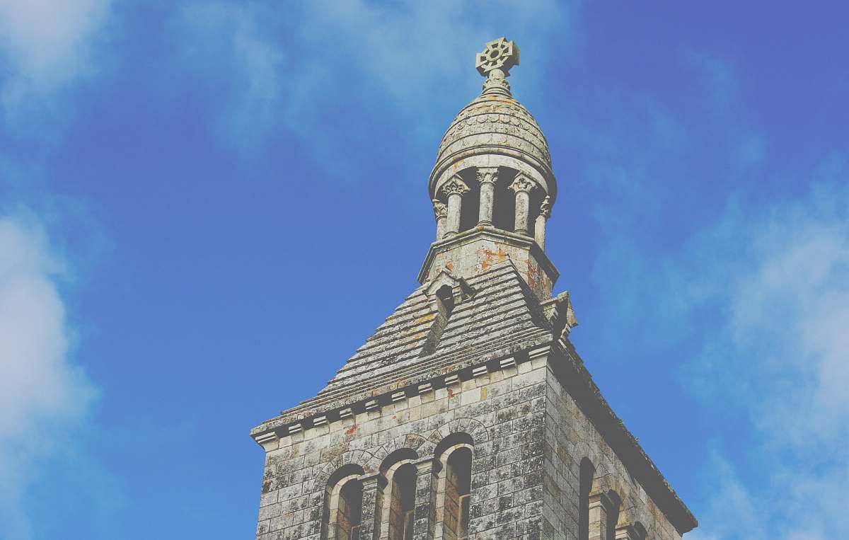 building low angle view photography of brown stone cathedral bell tower