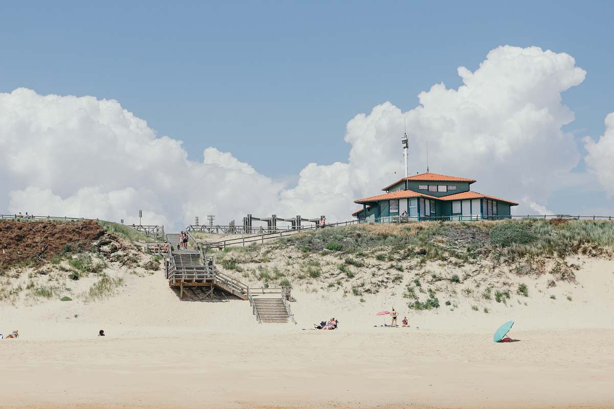 sand gray house under white clouds france