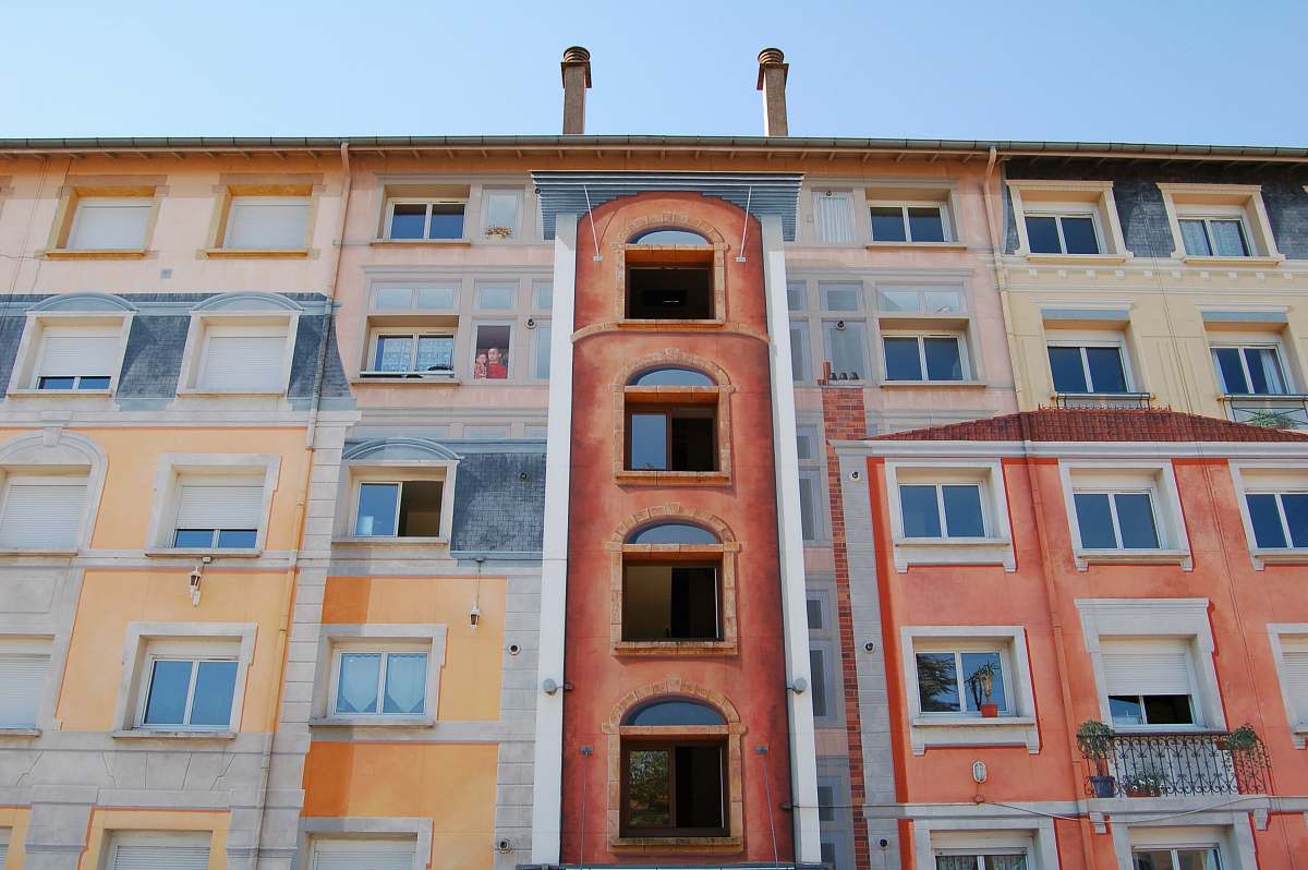 urban low-angle photography of brown and beige building apartment building