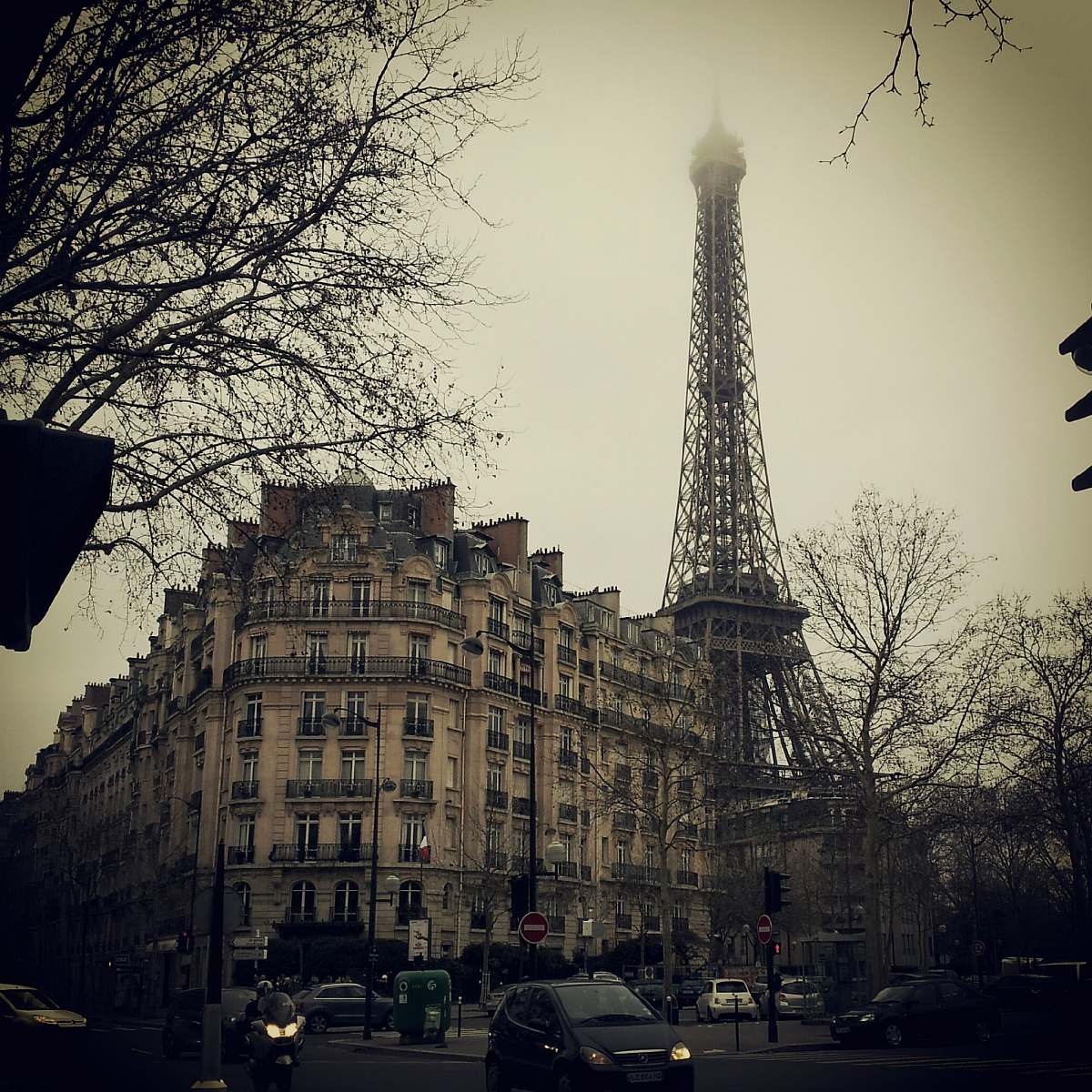 building Eiffel Tower behind concrete building tower