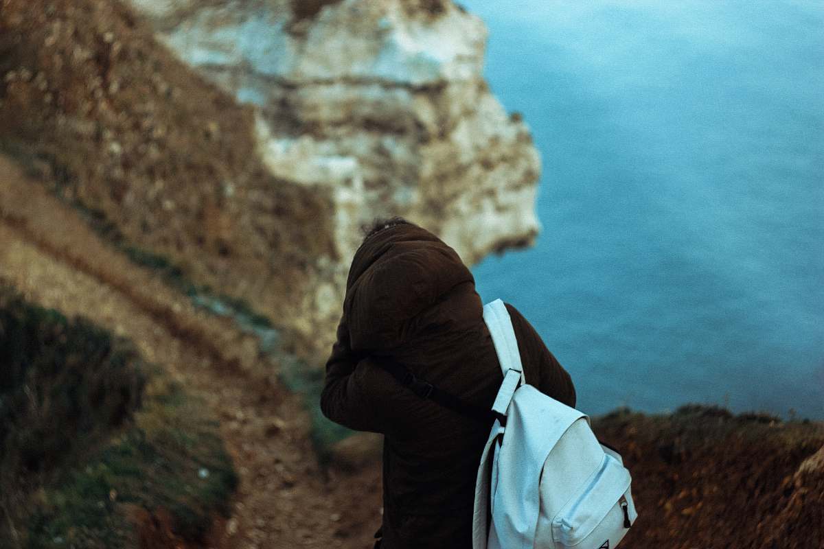 person person with blue backpack near body of water people