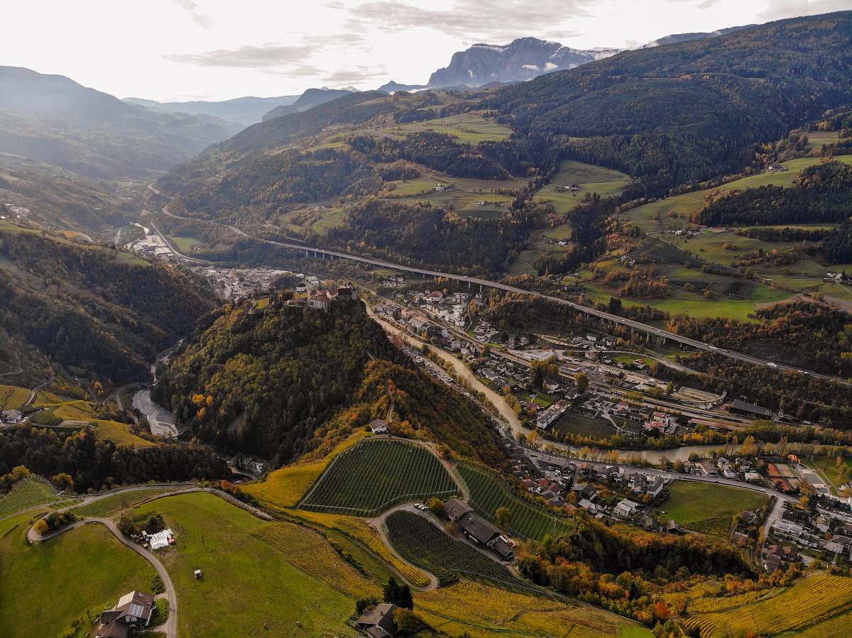 outdoors aerial photography of green fields and concrete roads at daytime scenery