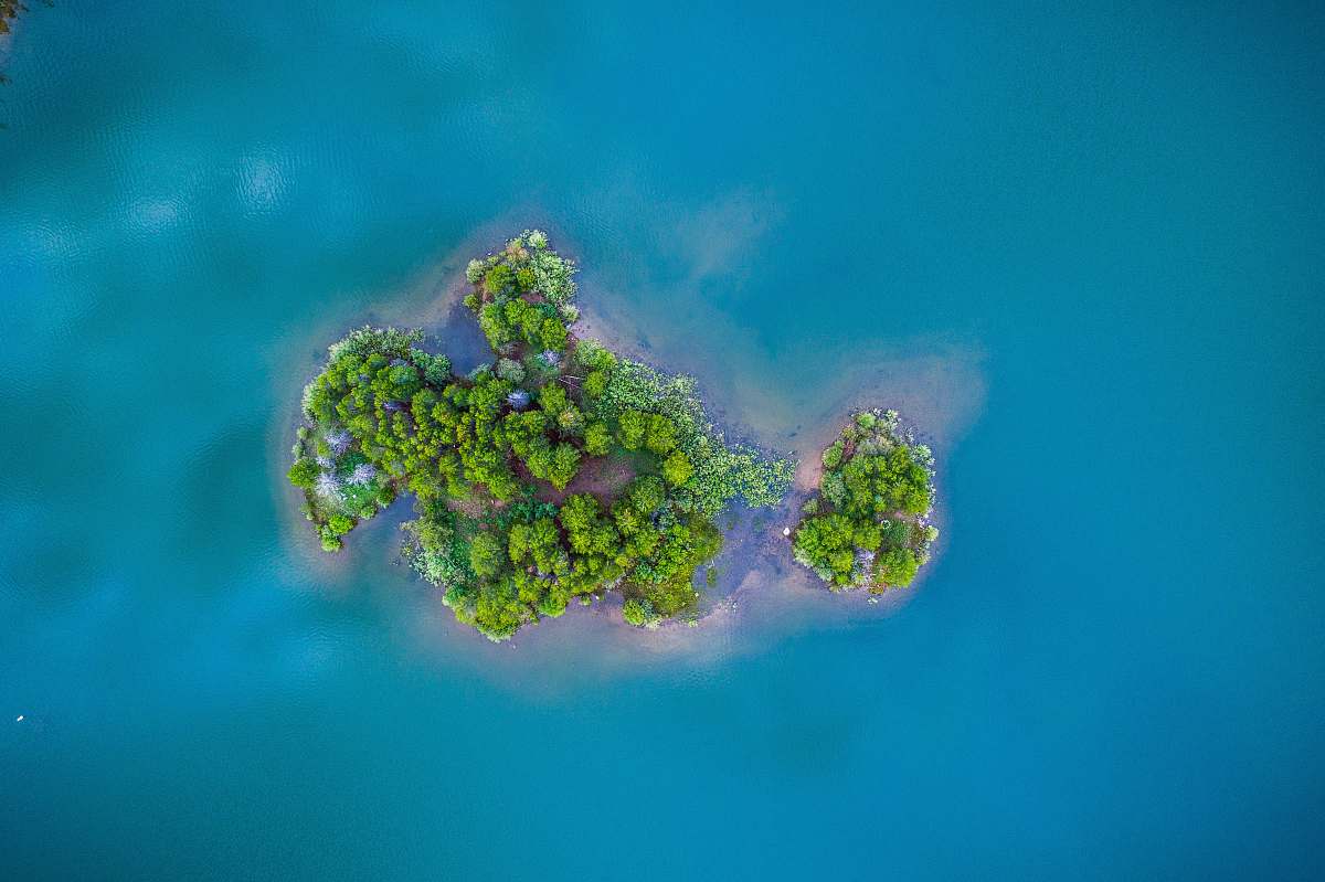 sea green island surrounded by body of water water