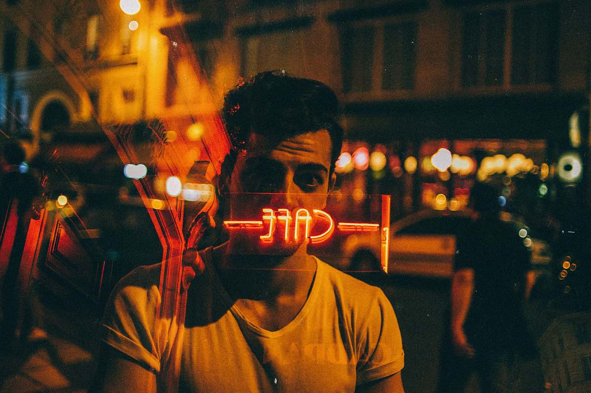 france man looking on glass at nighttime human