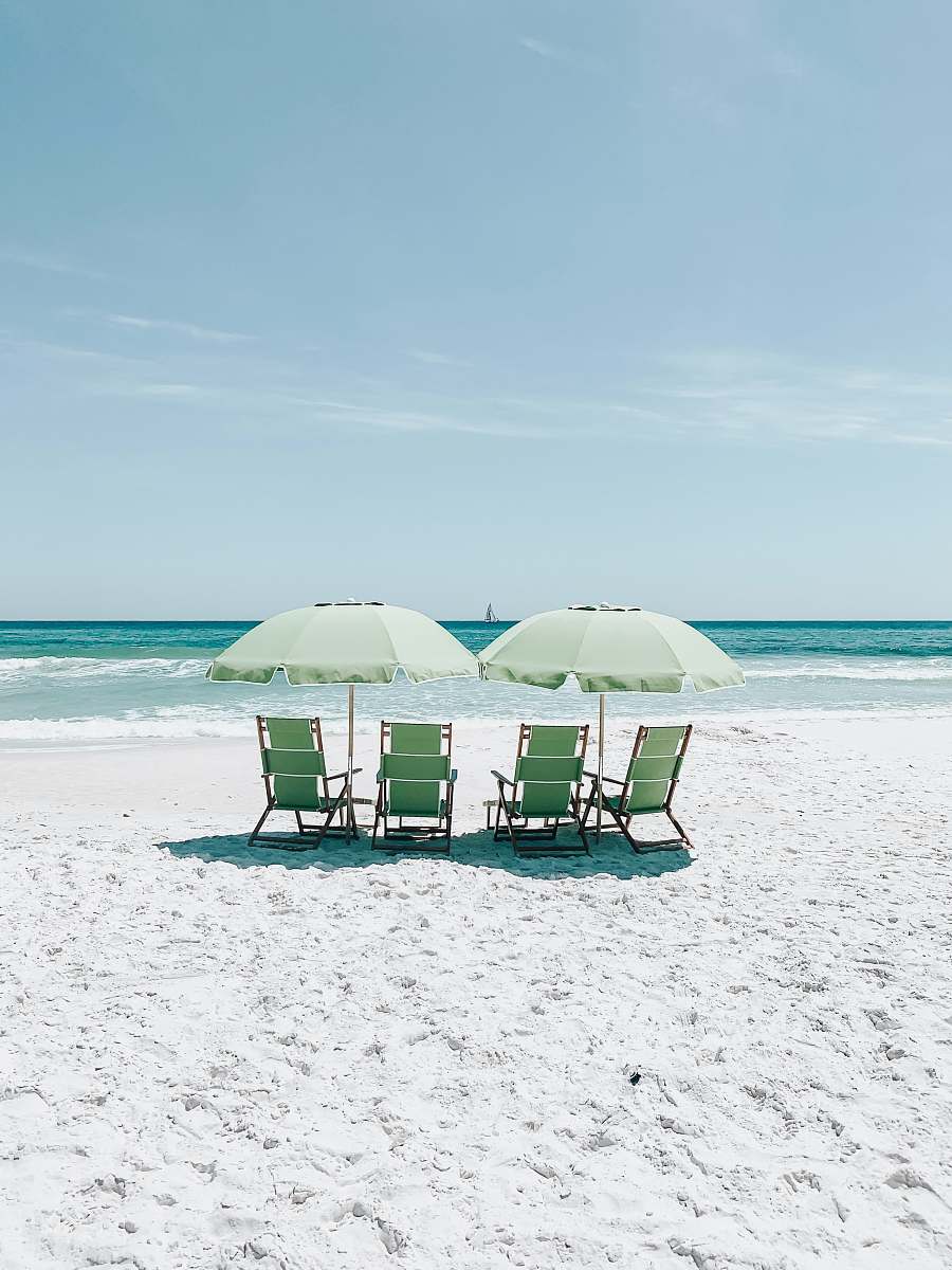 beach green chairs under umbrellas on shore chair