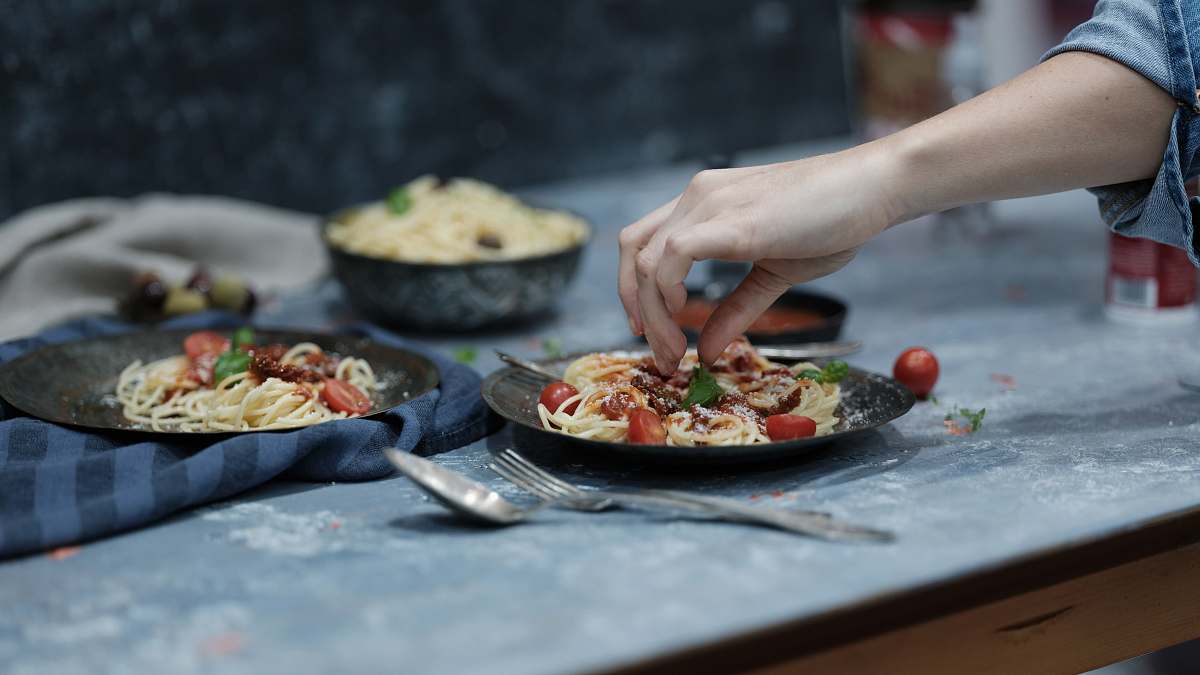 dinner person holding spaghetti sharjah