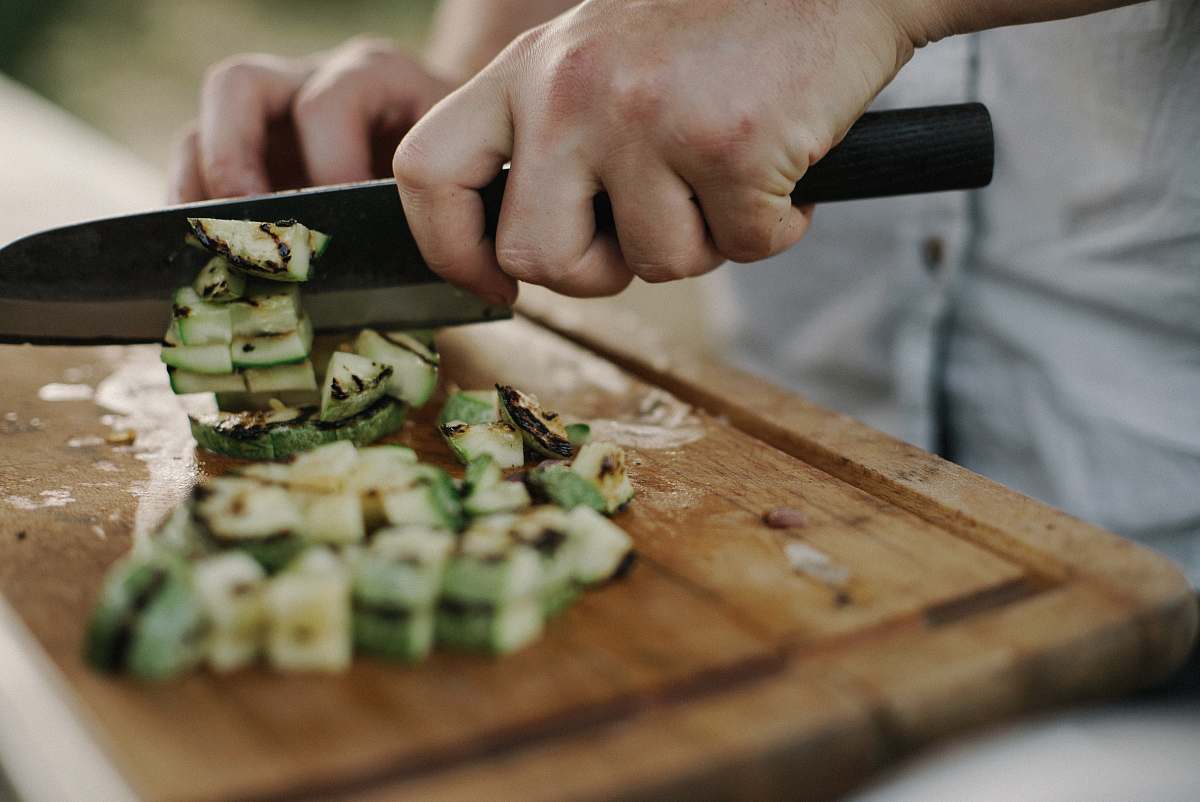 sushi person slicing on the wooden board vegetable