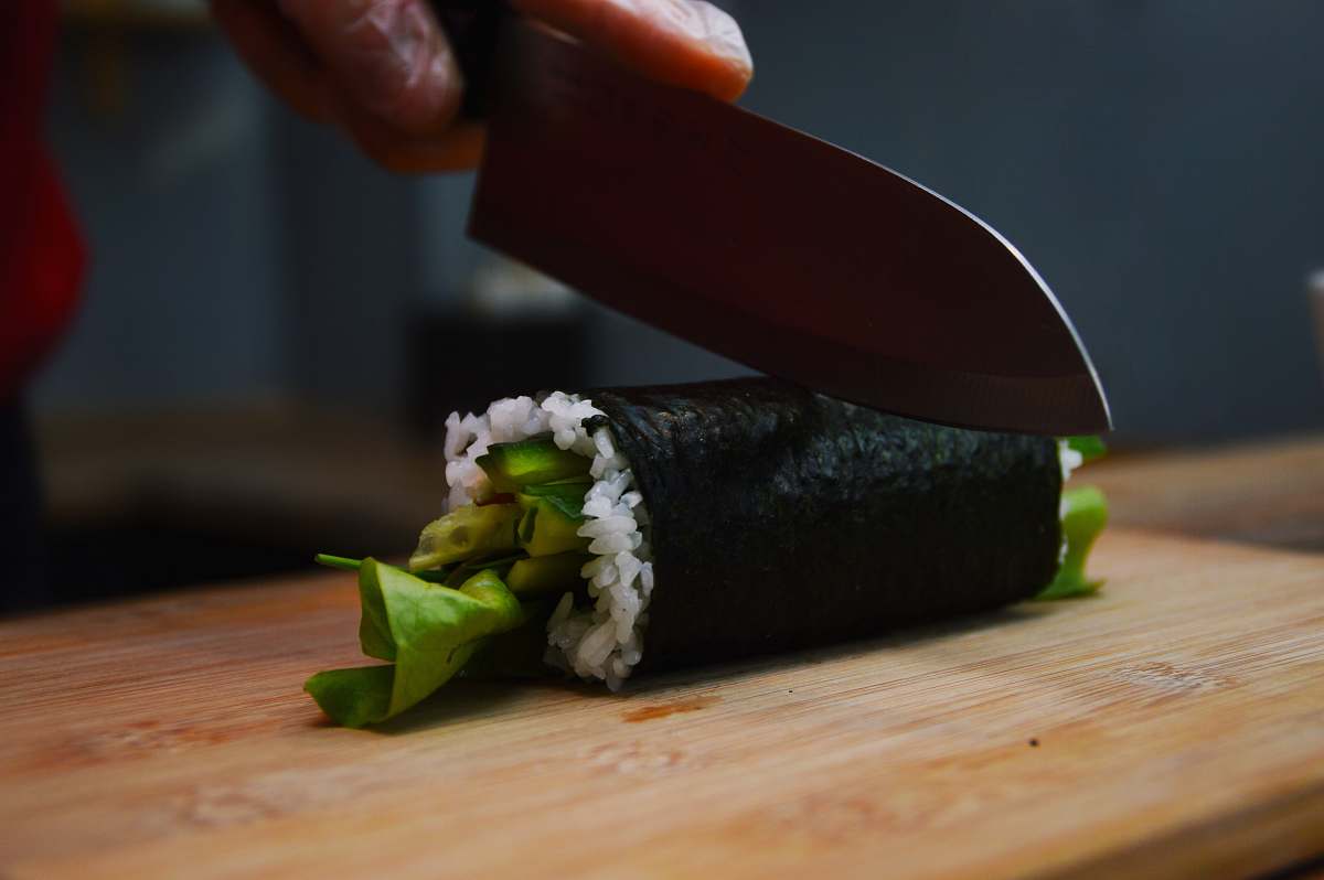 plant shallow focus photo of person cutting sushi ozimska 28