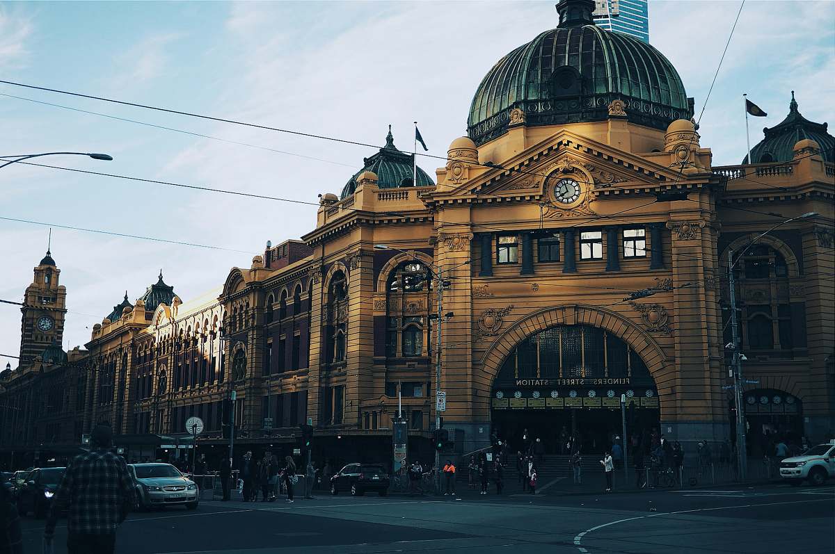 melbourne brown building with cars passing infront building